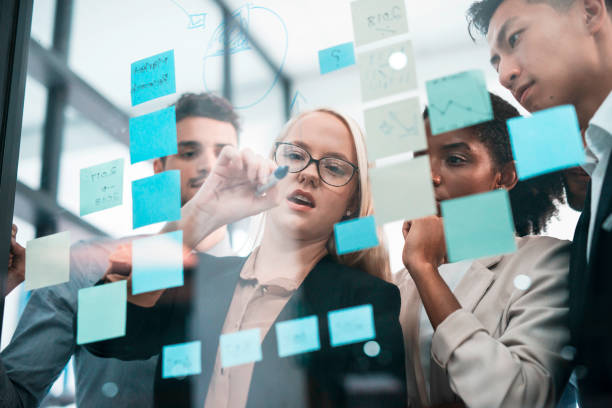 istock Innovative Team Collaborating on Business Ideas Using Colorful Sticky Notes for Effective Planning 2190640353