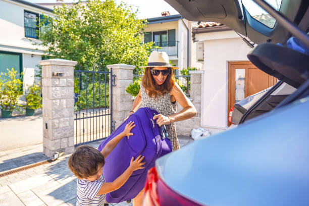 istock Mother and son loading luggage into car for summer vacation 2190640957