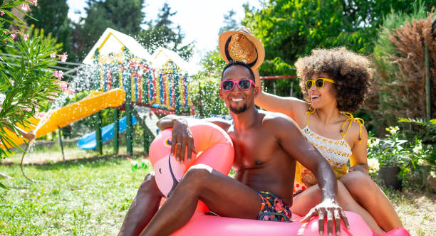 istock Afro Couple having fun on backyard at home during their summer vacation 2190642899