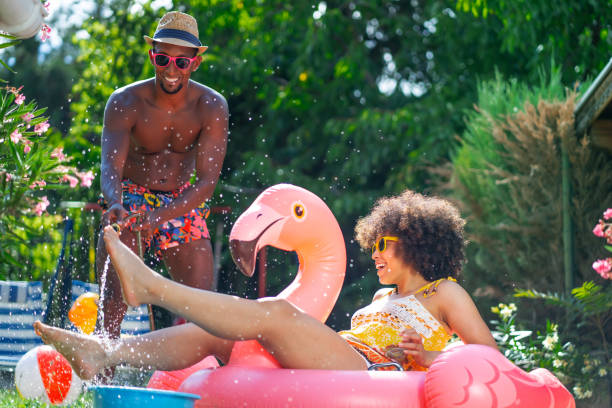 istock Afro Couple having fun on backyard at home during their summer vacation 2190642905