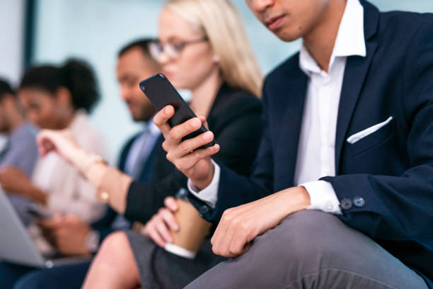 istock Multiethnic Professionals Engaged in Pre-Meeting Activities Including Smartphone Usage 2190643721