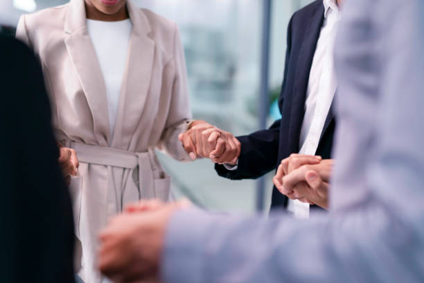 istock Team Holding Hands Together in a Circle, Symbolizing Support and Unity in the Office 2190643759