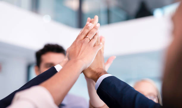 istock Business Team Celebrating Success with a Group High-Five in a Modern Office Environment 2190643765