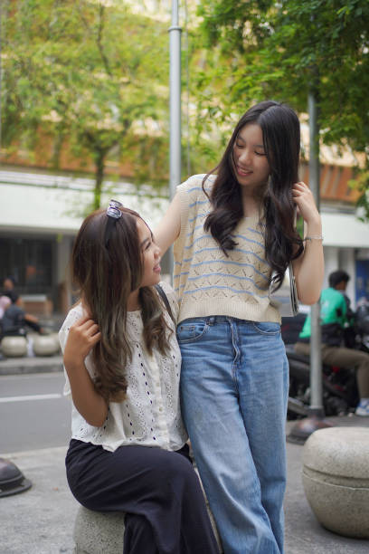 istock two asian women on the street 2190646535