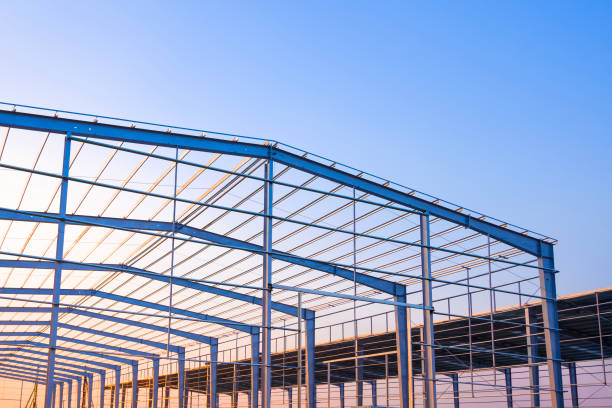 istock Factory building framework with metal post and roof beam structure  in construction site against evening sky background 2190648050
