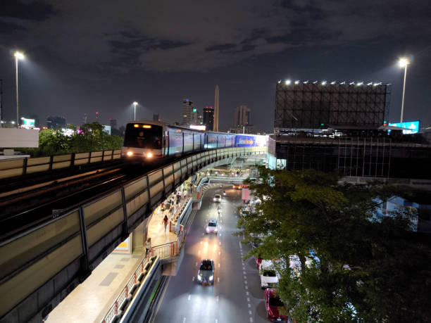 Bts Skytrain riding by night at Victory monument in Ratchathewi district, Bangkok, Thailand.