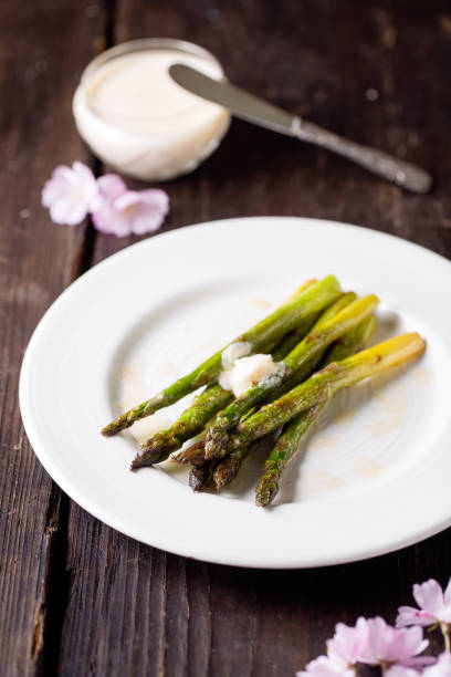 istock Fresh cooked green asparagus served with vegan butter 2190649454