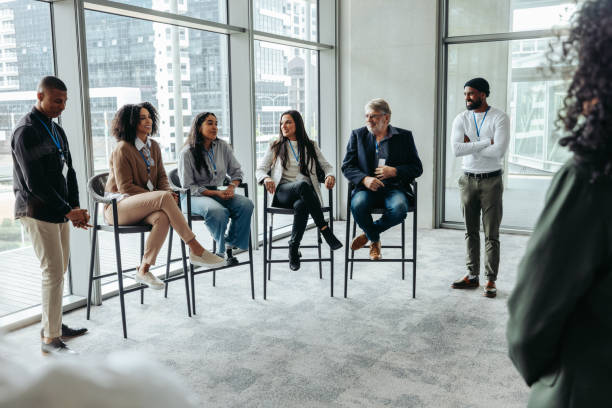 istock Diverse professionals engaging in a panel discussion at a corporate event, sharing insights and expertise in a modern conference room setting. 2190649930