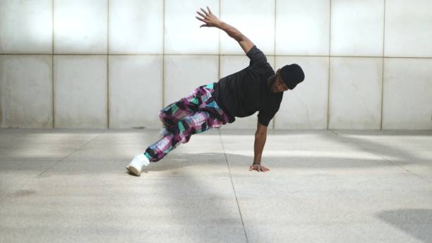 istock Breakdancer performing freeze move in urban environment 2190650519