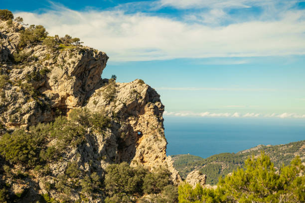 Amazing elephant shaped rock mountain on a sunny day with a blue sky and the sea in the background