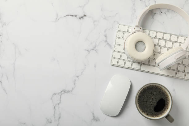 istock A cup of coffee with headphones and a keyboard on a white background 2190650954