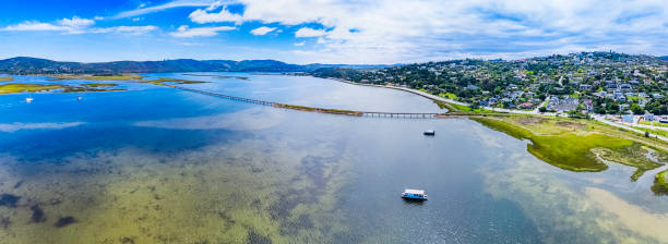 Knysna is built on the northern shore of a large warm-water estuary, known as the Knysna Lagoon, which is fed by the Knysna River. The estuary opens to the ocean passing through two large rock formations made up of quartzites known as \