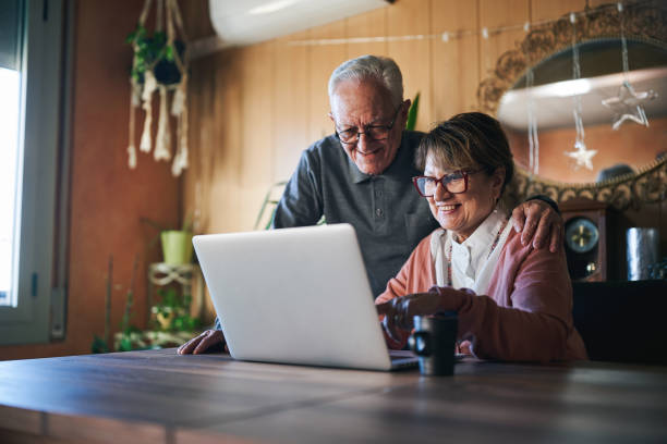 istock Elderly couple using a laptop together at home 2190653037