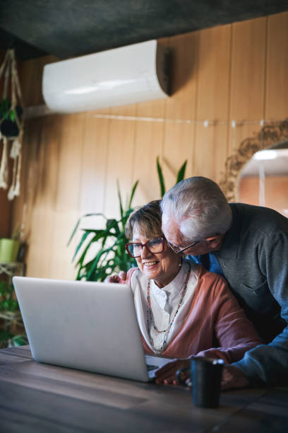 istock Happy elderly couple using a laptop together at home 2190653046