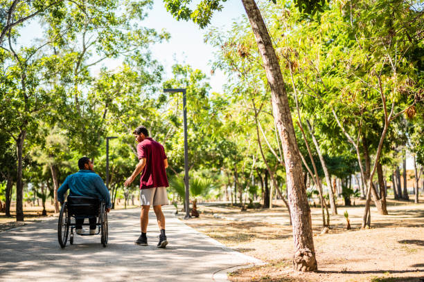 istock Friends talking and walking on public park 2190654153