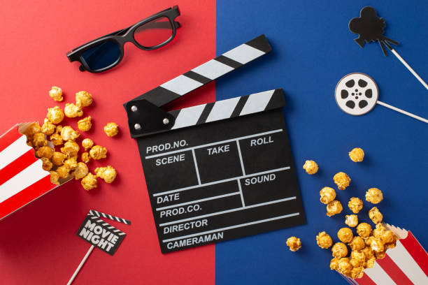 istock A creative flat lay featuring a clapperboard, popcorn, 3D glasses, and a movie reel on a vibrant colored background, perfect for a movie night theme 2190654182