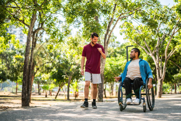 istock Friends talking and walking on public park 2190654183