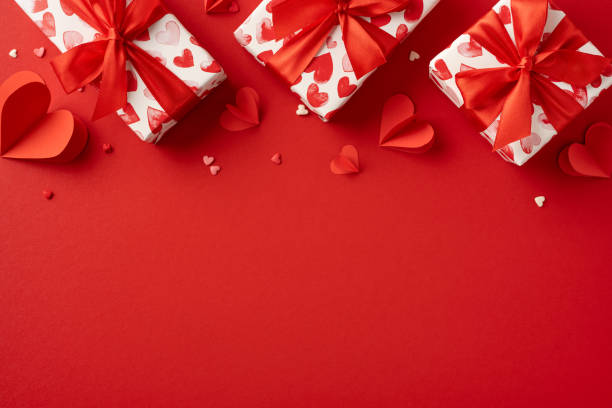 istock Three beautifully wrapped gift boxes with red ribbons and paper hearts, perfect for a romantic Valentine's Day celebration. The vibrant red tones create a warm and loving atmosphere 2190654231