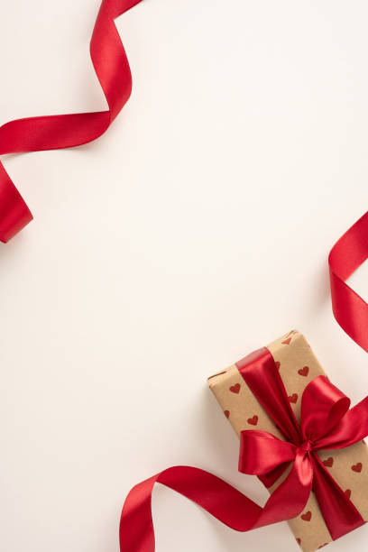 istock A vertical beautifully wrapped gift box with a red ribbon features heart patterns, perfect for celebrating love and special occasions such as Valentine's Day or anniversaries 2190654326