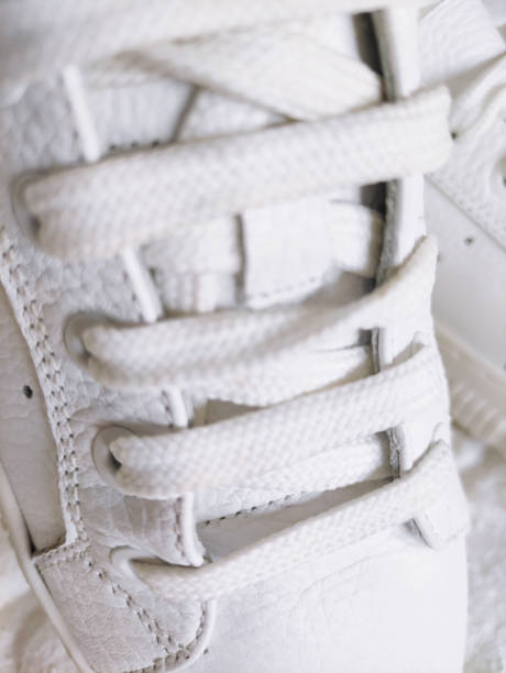 istock White laces in white sports sneakers 2190654632