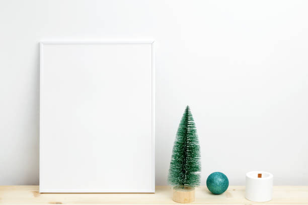 istock White frame for mockup with thuja branches in a vase decorated with Christmas ornaments 2190655512