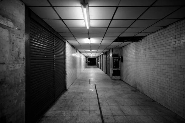 Square, oppressive gallery with daylight above and tile floor, symmetrical composition