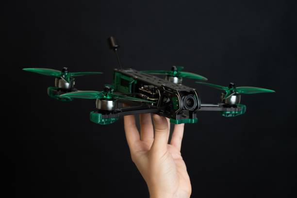 istock Professional modern drone with digital camera in hand on black background 2190656574