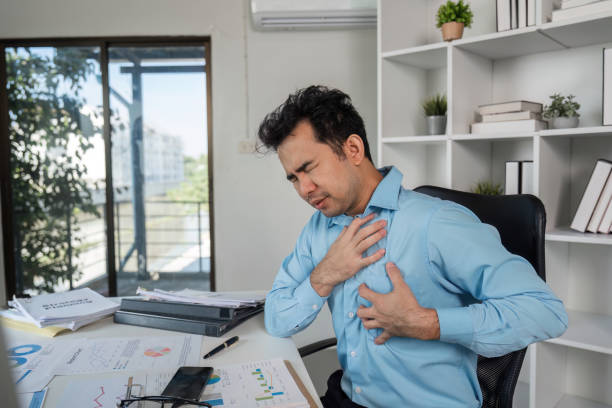 istock Overcoming health problems through hard work a businessman's struggle in a office environment 2190656765