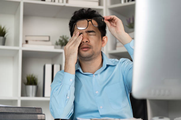 istock Tired professional struggles with hard work at office desk workspace stressful environment close-up view 2190657854