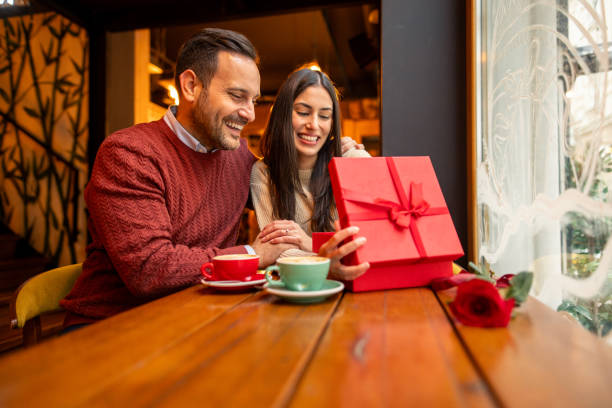 istock Joyful Caucasian Female Opening Valentines Day Gift in Cafe 2190658372