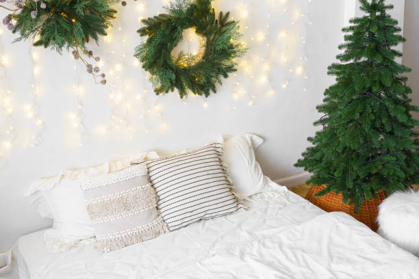 istock Christmas tree and wreath in bedroom, holiday decor and warm lighting during winter months 2190659321