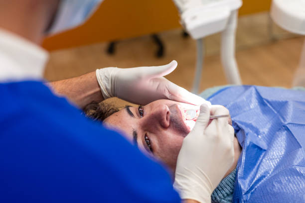 istock Dentist performing dental check-up on young adult patient 2190664549
