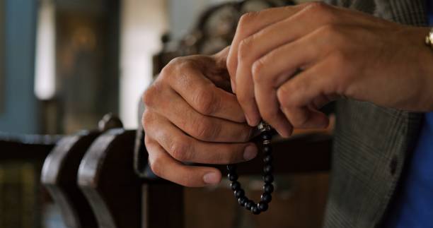 istock Hands Cradling Prayer Beads Symbolize Calm Mindfulness and Spirituality, Inviting Deep Personal Reflection and Introspection During Meaningful Meditation Sessions, Prayer with Rosary in Hands. 2190667049