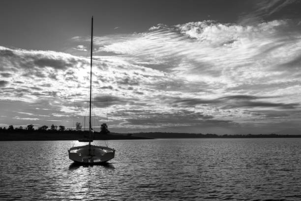 istock Serene sailboat on calm waters at sunset. 2190667365
