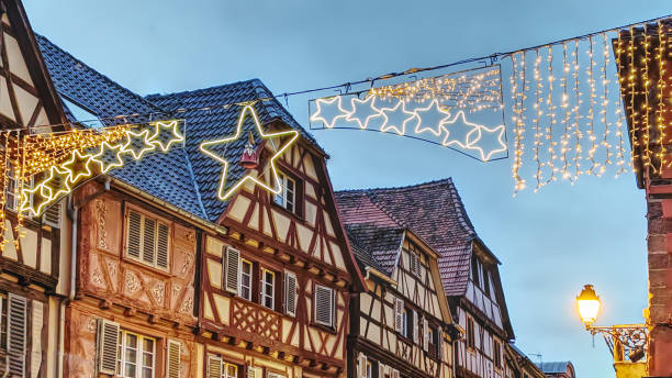 istock Charming half-timbered houses adorned with decorations in a quaint village during festive season, Bouxwiller, Alsace, France 2190667947