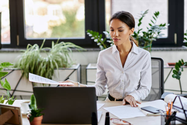 istock Focused young businesswoman navigating tasks in a modern office environment 2190667961