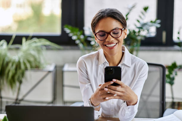 istock Young Black businesswoman using her smartphone in a lively office 2190668080