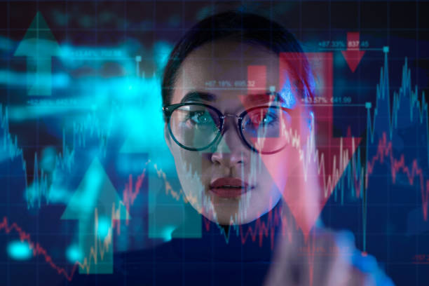 istock Woman analyzing stock market data graphs 2190670173