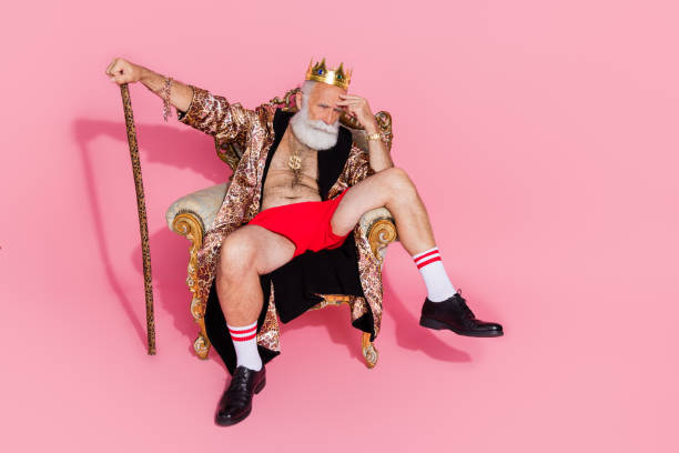 Full size photo of eccentric man leopard robe gold crown halloween costume empty space isolated on pink color background