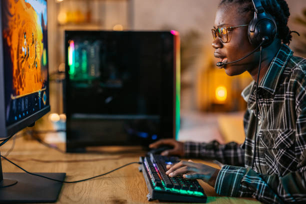 istock Young Black Woman Playing A Video Game On Her Desktop PC 2190671515