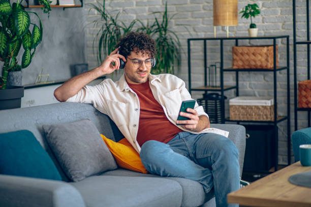 istock Man relaxing at home with music and smart phone 2190671907