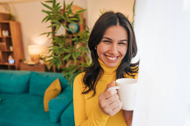 istock A young woman enjoys the view while warming herself with tea 2190671923