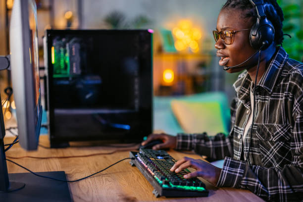 istock Young Black Woman Playing A Video Game On Her Desktop PC 2190671960