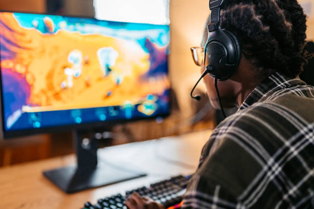 istock Young Black Woman Playing A Video Game On Her Desktop PC 2190672070