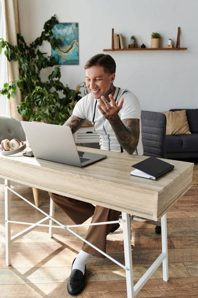 istock Handsome young man with tattoos engaging in vibrant conversation at modern workspace 2190672706