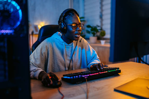 istock Young Black Woman Playing A Video Game On Her Desktop PC 2190673202