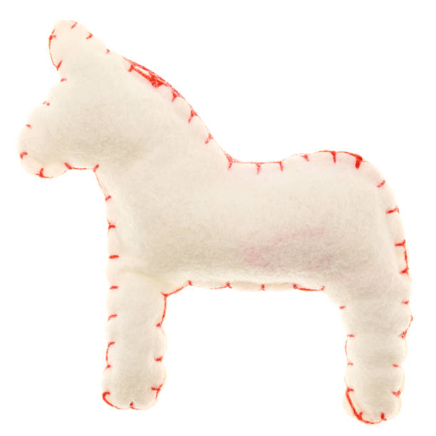 White handmade felt horse toy with decorative red stitching along the edges isolated on white background