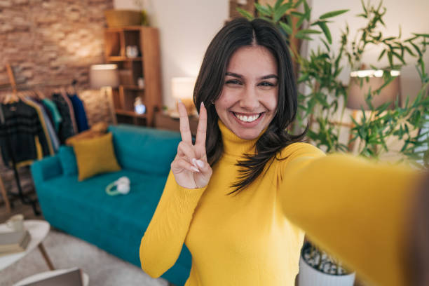 istock Beautiful young woman taking selfie at home 2190675295