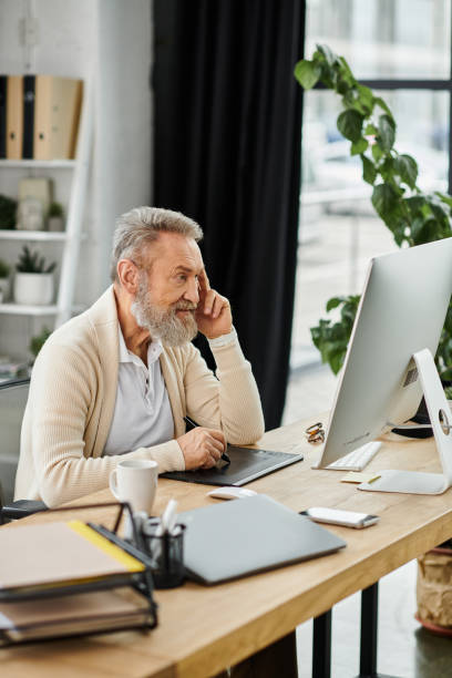 istock Experienced businessman focused on work in a modern corporate office setting 2190675330