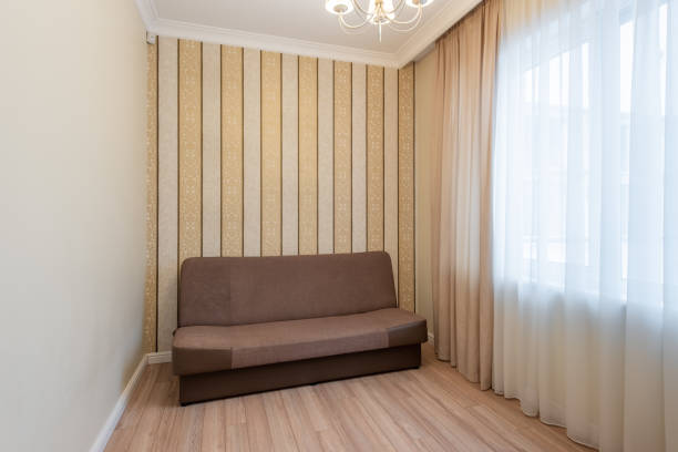 istock Cozy Home Room With Sofa Featuring Elegant Drapes and Patterned Vertical Wallpaper. Interior 2190677497